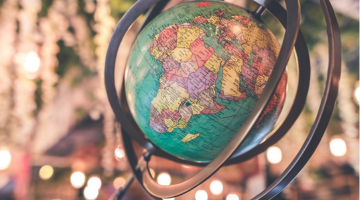 A globe with lights with a bokeh effect in the background