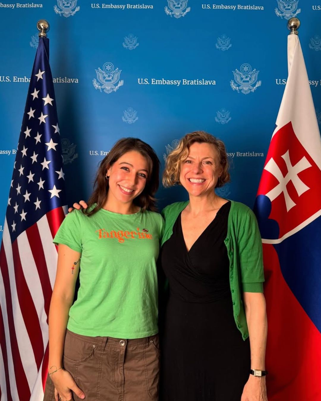 Post-bacc student in front of flags