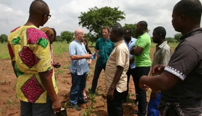 Staff of the Global Poverty Research Lab meet with a group of villagers in Ghana