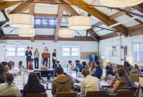 Undergraduates stand on stage giving a speech during the peace simulation.
