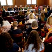 Panelists in front of a full room