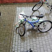 Bicycles parked on wet cobblestones in Kornalovichi, Ukraine.