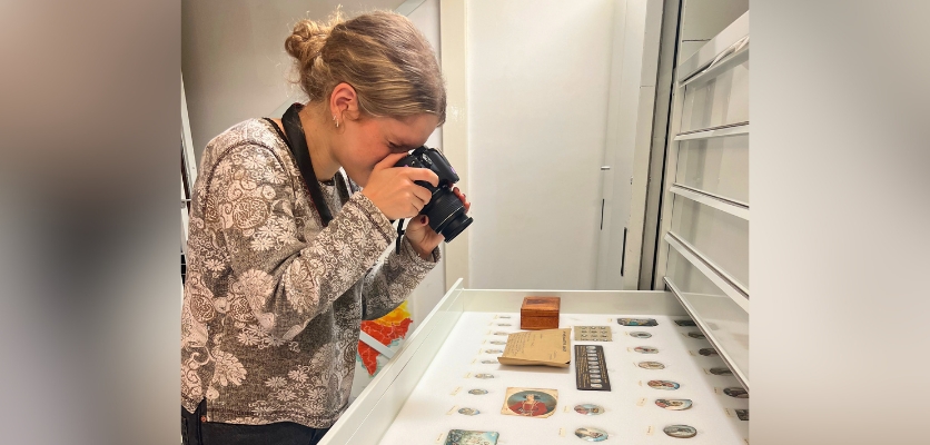 Lowry photographing artifacts while conducting archival research in Europe.