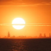 The sun rising over a city