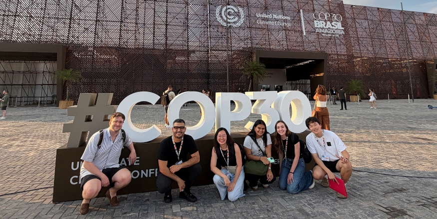 Group photo in front of COP30 sign