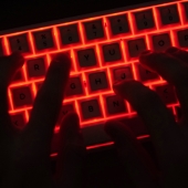 Hands on an LED keyboard.