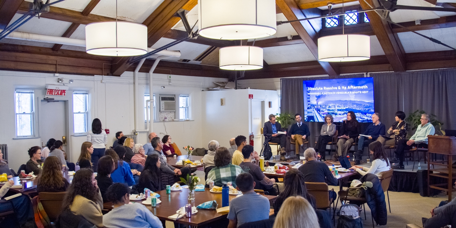 Faculty talking on stage
