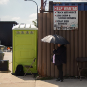 A vendor standing near Cermak Road in Pilsen protects themselves from the sun on a day when temperatures reached as high as 91 degrees.