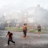 Neighbors and kids play in the water from a fire hydrant in Albany Park as Chicago reached record-breaking high temperatures on Aug. 23, 2023.