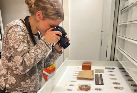 Buffett Undergraduate Research Fellow Elizabeth Lowry photographing artifacts while conducting archival research in Europe