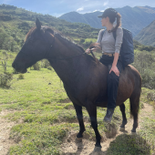 Graduate student on university-affiliated travel abroad riding a horse. She registered her trip in Northwestern University's International Travel Registry to receive  health and safety resources and reach out in an emergency abroad.