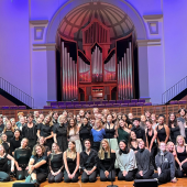 A large group of performers on a stage