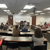 An audience listening to a talk at Loyola University