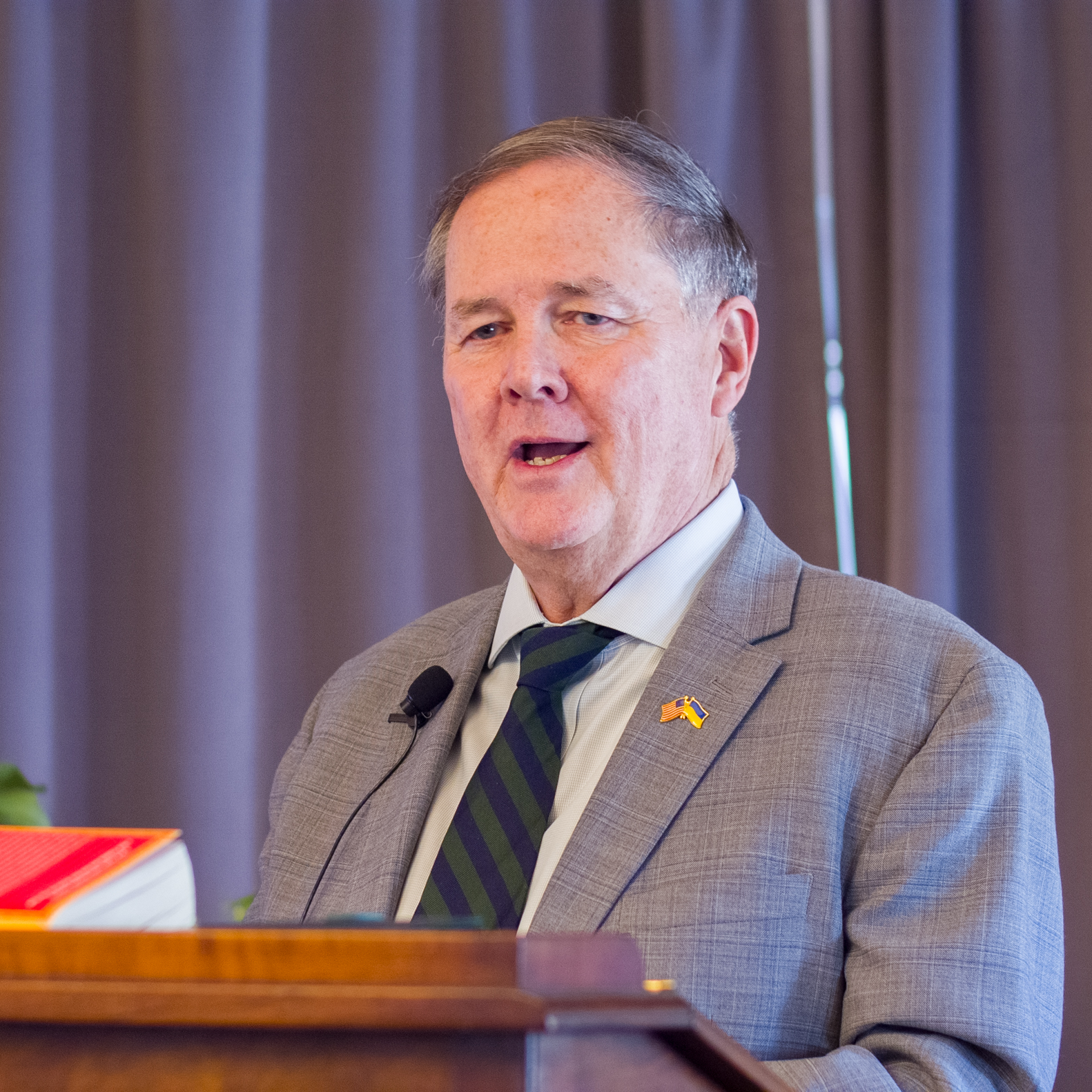 Image of Thomas O. Melia at the podium in the Buffett Reading Room