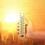 A graphic of a hand holding a thermometer during a heat wave.