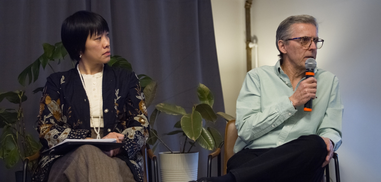 Faculty talking on stage