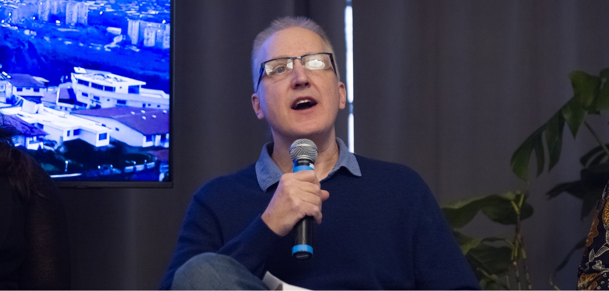 Faculty talking on stage