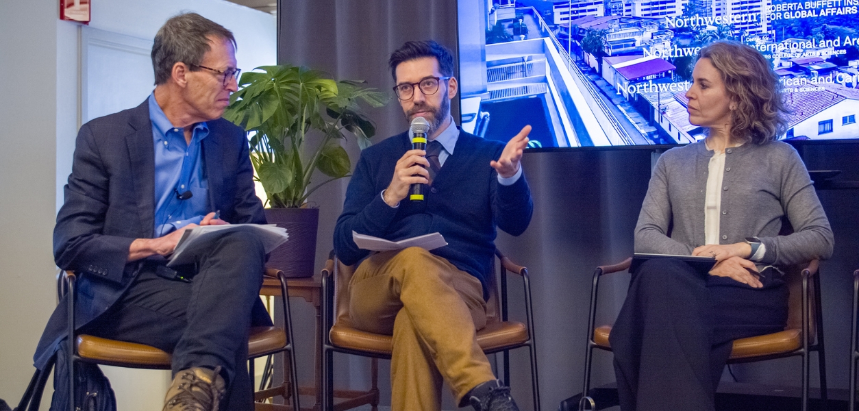 Faculty talking on stage