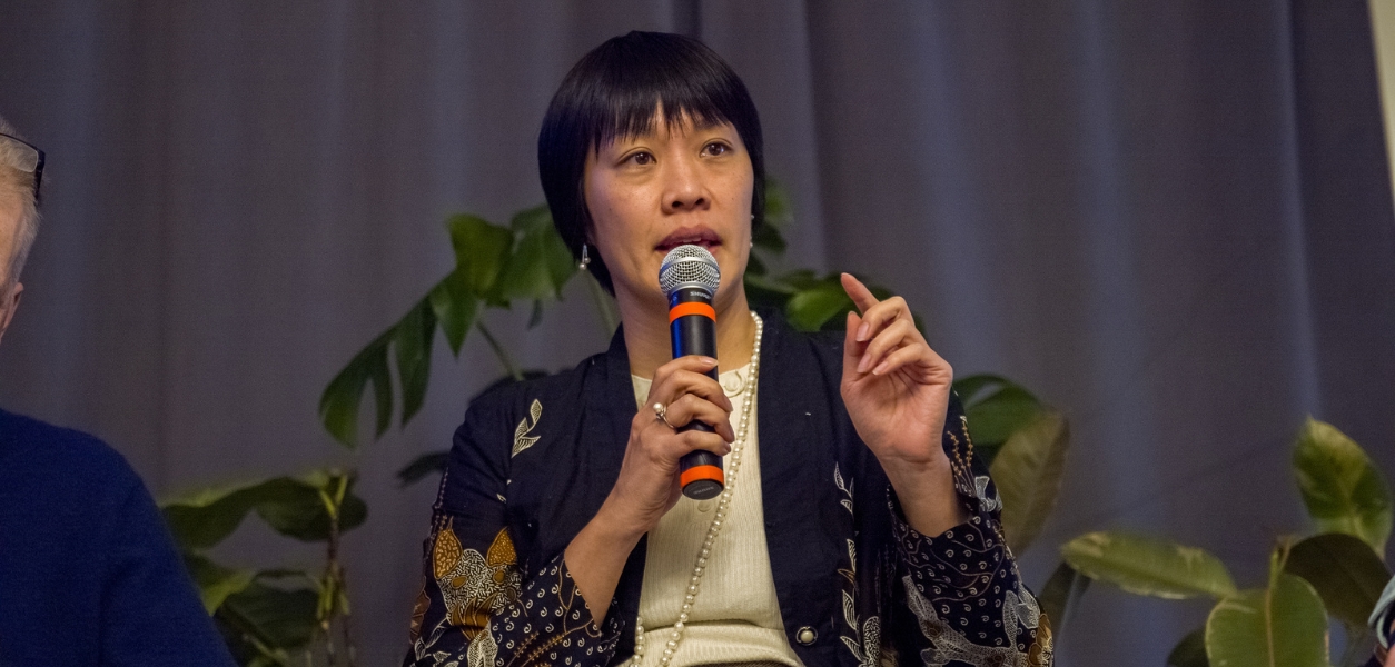 Faculty talking on stage