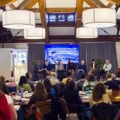 Faculty talking on stage