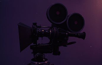 A dark video camera image on a dark purple background.