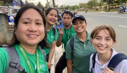 Post-Bacc fellow Olivia Case taking a photo with a group of coworkers