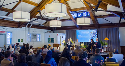 photo of the Buffett reading room, where the first panel of the symposium speaks to an attentive audience