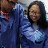Researchers at Lucks Laboratory look at the results of a water test strip. The visible markers on these strips indicate the presence of different contaminants, such as lead and fluoride, in a water sample.