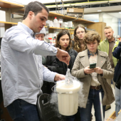 Tyler Lucci shows a group of Northwestern University students how components of a biosensor test are freeze-dried.