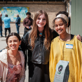 Image of students in front of a mural